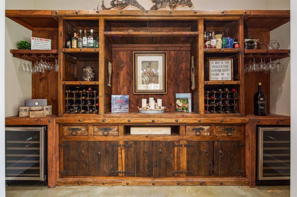 The custom wine room is truly stunning & features two wine refrigerators.