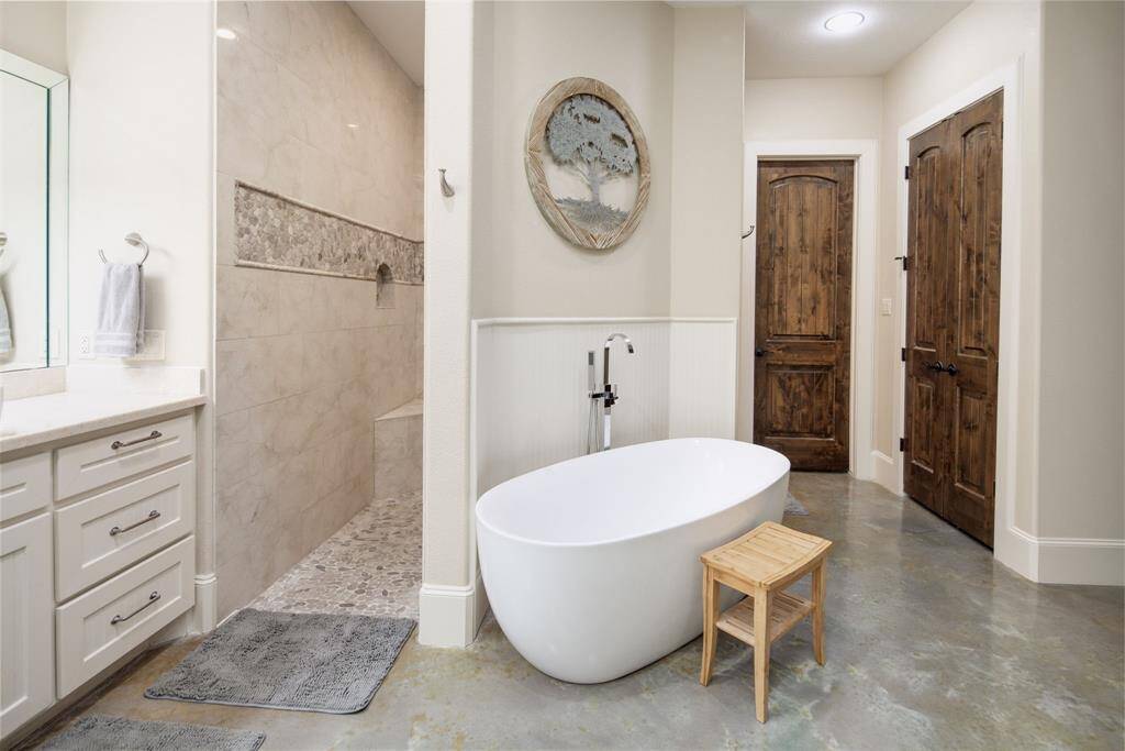 Pictures do not even do this space justice...you'll love the pass through shower with 3 shower heads. The freestanding tub is perfectly placed to enjoy the fireplace and create a spa-like atmosphere.
