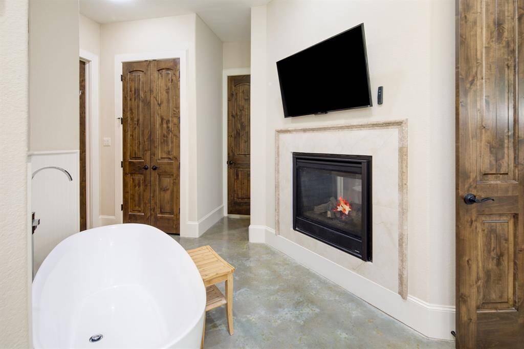 Another view of the spa-like freestanding tub. For convenience, the primary suite connects directly to the laundry room.
