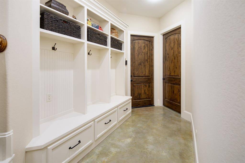 Coming inside from the 3 car garage, you'll see the mudroom that is well appointed with more custom cabinets & storage.