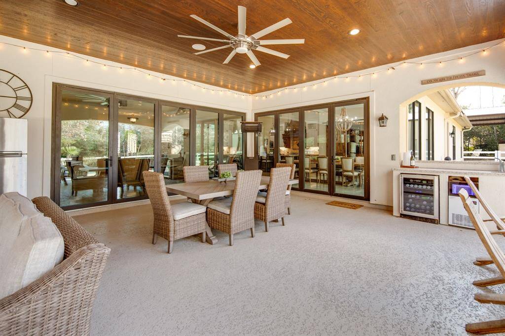 Covered patios in Texas are an absolute must & this one does NOT disappoint! Dining areas, bar area, outdoor kitchen & full fireplace!