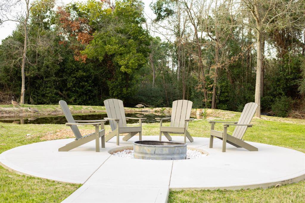 Custom firepit area overlooking the property's pond.