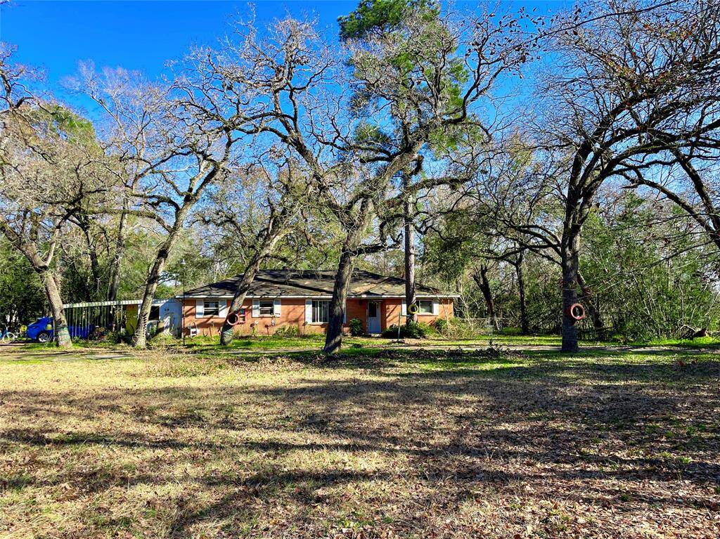 View of the expansive front yard, which is set far back from the street for privacy.