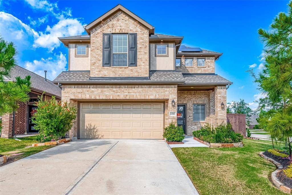 This is a modern two-story brick house with a two-car garage. It features a beautiful landscaped front exterior with a front porch. Cornet lot!