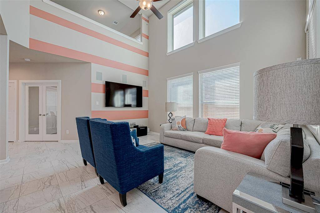Double-story ceilings fill this home with an abundance of natural light. Accent wall adds character & interest to the space. Gather around with your family & friends and make the best of memories here!