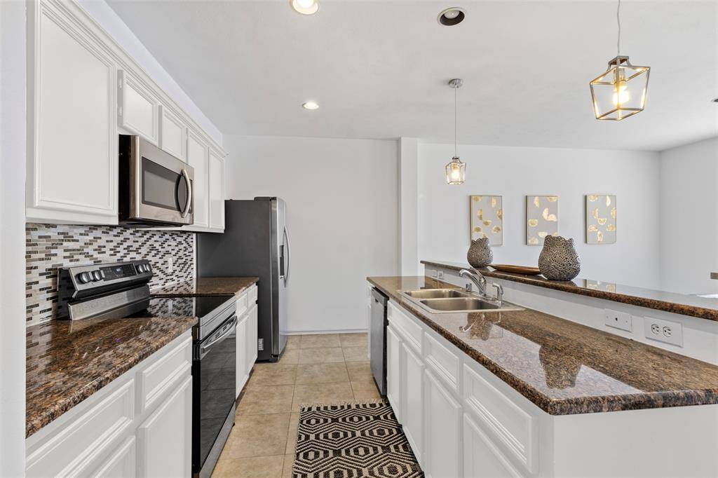 Step into a contemporary culinary haven where the kitchen effortlessly flows into the dining area, creating a harmonious space designed for both functionality and style. The kitchen features sleek, modern cabinetry with a sophisticated finish, complemented by a large island that serves as both a prep space and a casual eating spot.