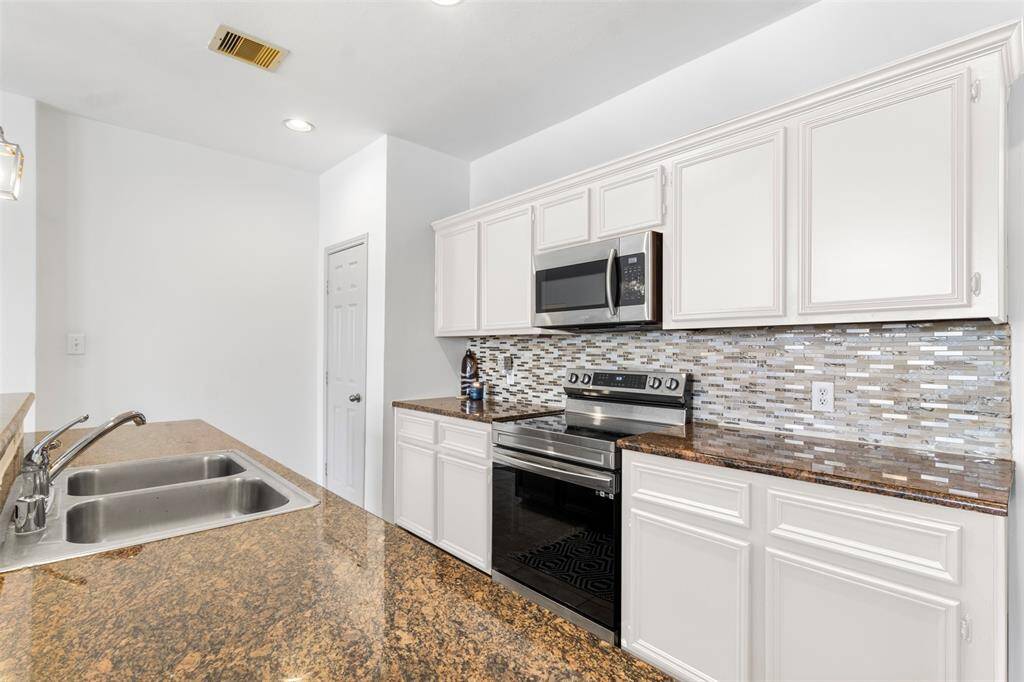 Step into a contemporary culinary haven where the kitchen effortlessly flows into the dining area, creating a harmonious space designed for both functionality and style. The kitchen features sleek, modern cabinetry with a sophisticated finish, complemented by a large island that serves as both a prep space and a casual eating spot.