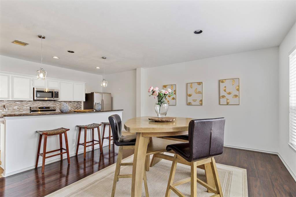 Step into a contemporary culinary haven where the kitchen effortlessly flows into the dining area, creating a harmonious space designed for both functionality and style. The kitchen features sleek, modern cabinetry with a sophisticated finish, complemented by a large island that serves as both a prep space and a casual eating spot.