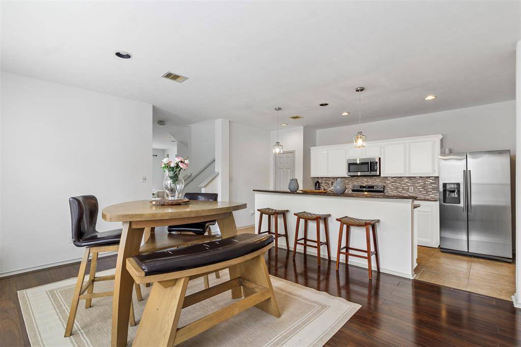 Step into a contemporary culinary haven where the kitchen effortlessly flows into the dining area, creating a harmonious space designed for both functionality and style. The kitchen features sleek, modern cabinetry with a sophisticated finish, complemented by a large island that serves as both a prep space and a casual eating spot.