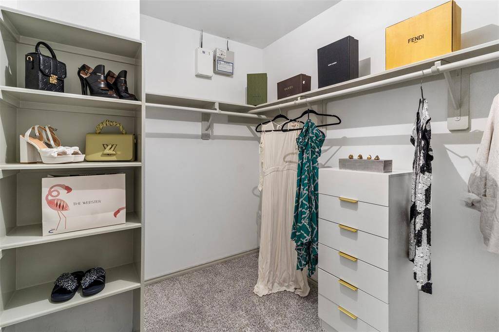 Keep your wardrobe organized in this generous walk-in closet.