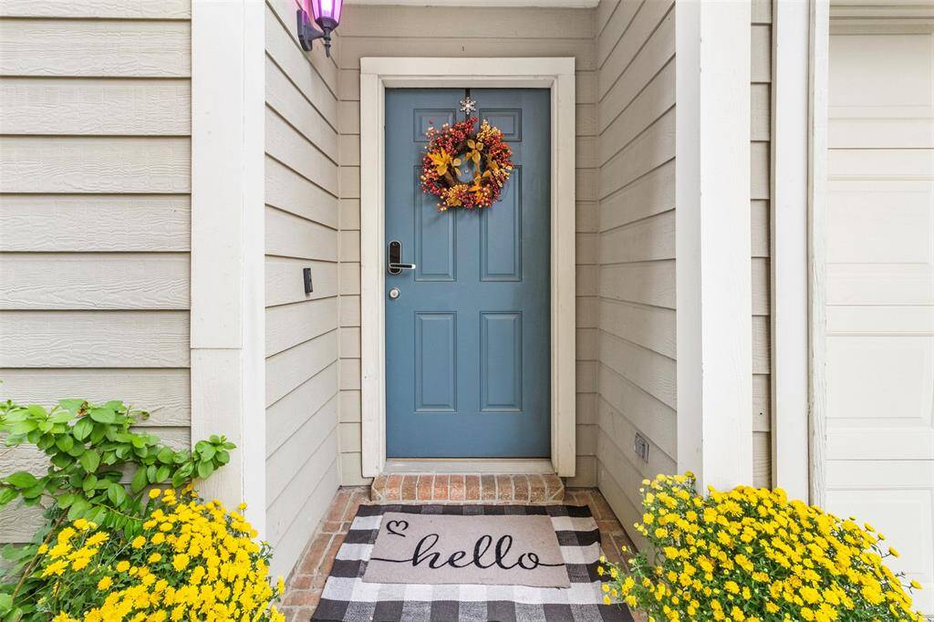 The well-maintained façade and stylish landscaping add to the home's curb appeal.