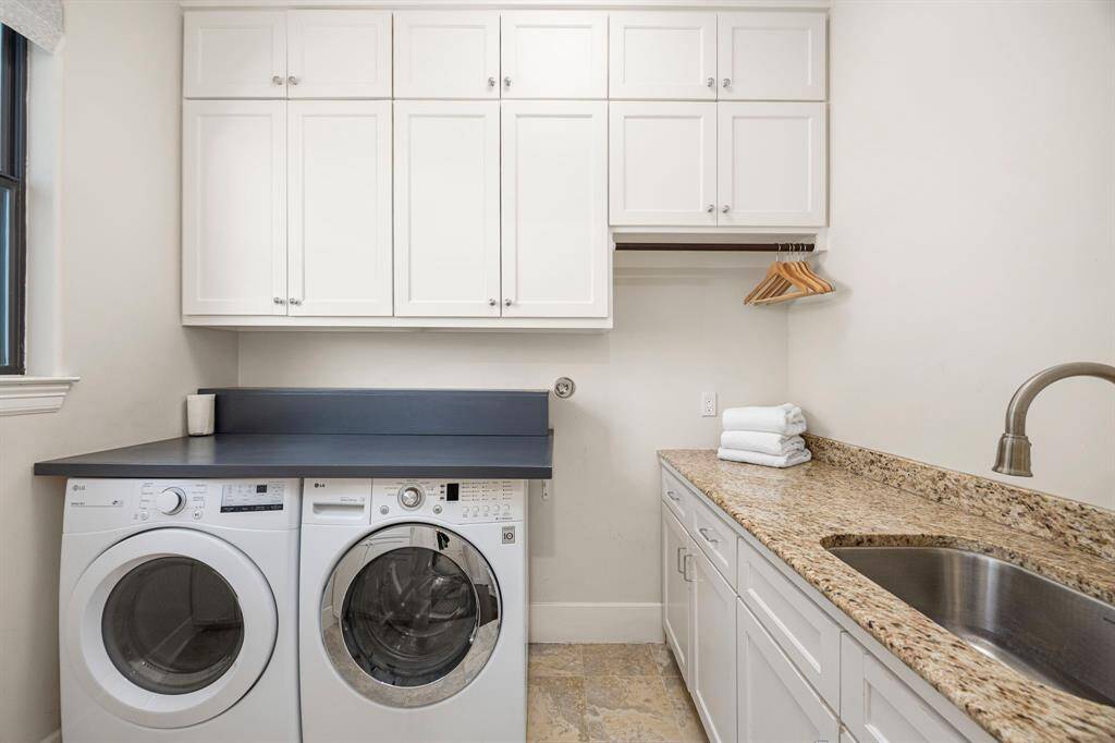 Laundry room with sink. More storage along wall not pictured.