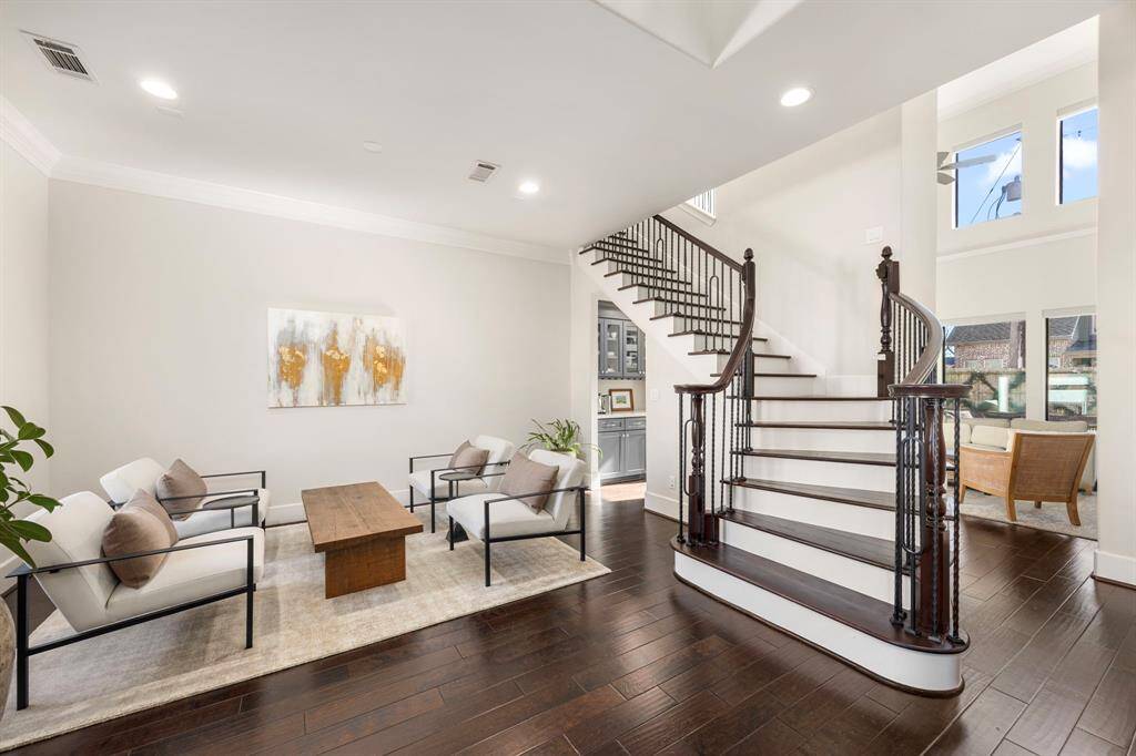 Impactful two-story front entry highlighted with grand staircase.