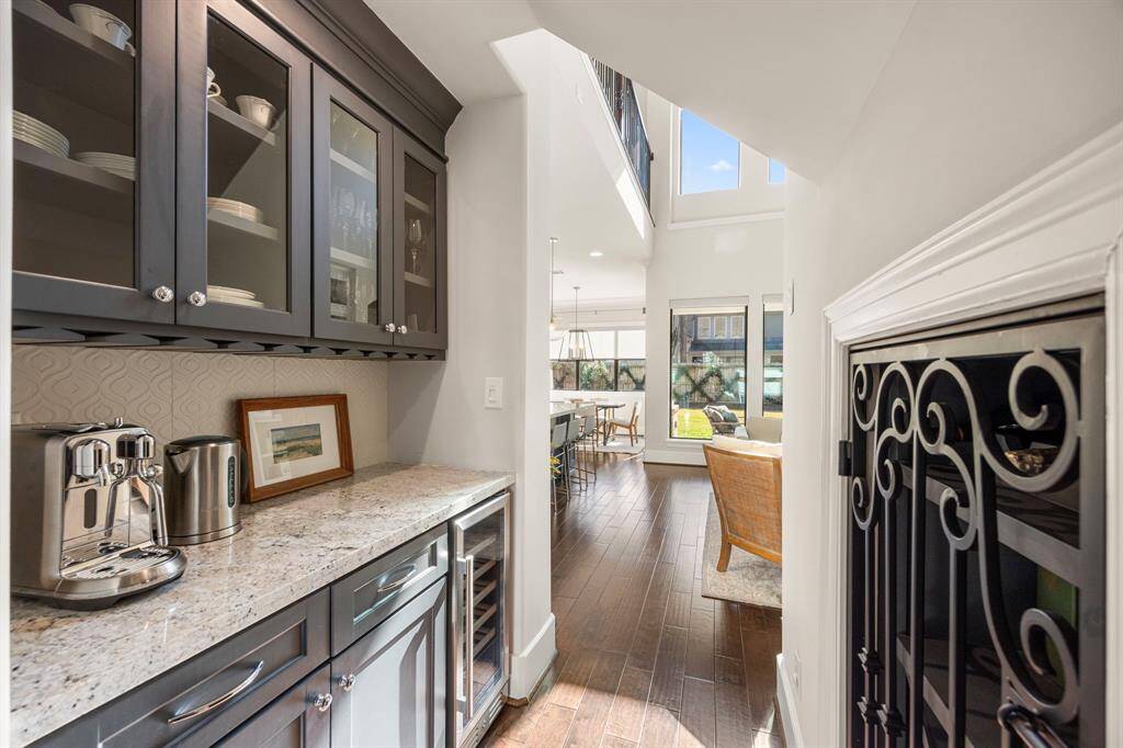 Perfectly located butlers pantry with wine fridge and wine storage behind the iron door.