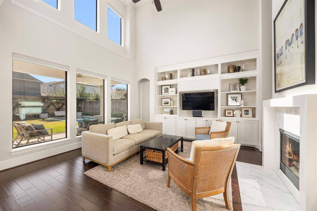 Light and bright living room with views of backyard and pool.