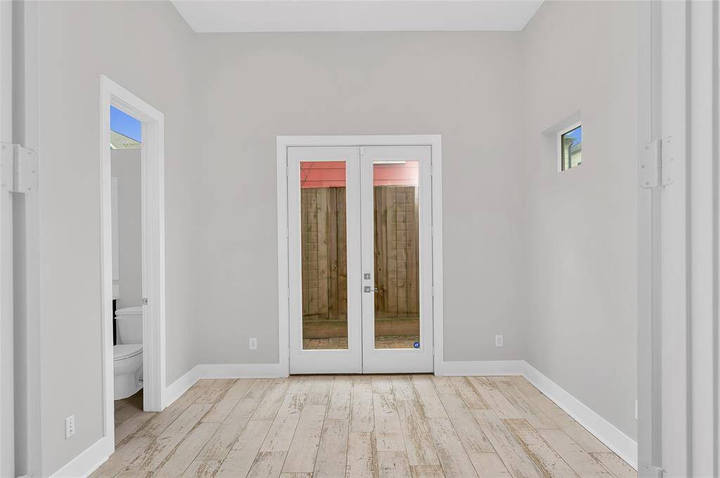 On floor 1 is a bedroom with full bath, walk-in closet and French doors that lead to the back yard.