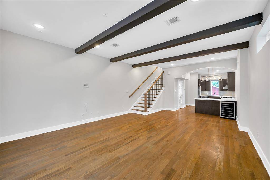 Plenty of room for entertaining in this open floor plan. Beautifully accented with wood beams, wood floors and recessed lighting