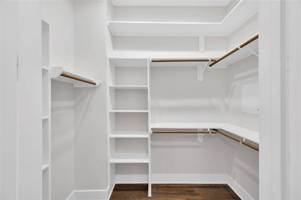 A fabulous walk-in primary suite closet behind french doors.