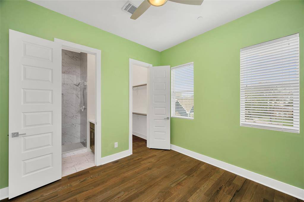 The secondary bedroom down the hall also features walk-in closets...