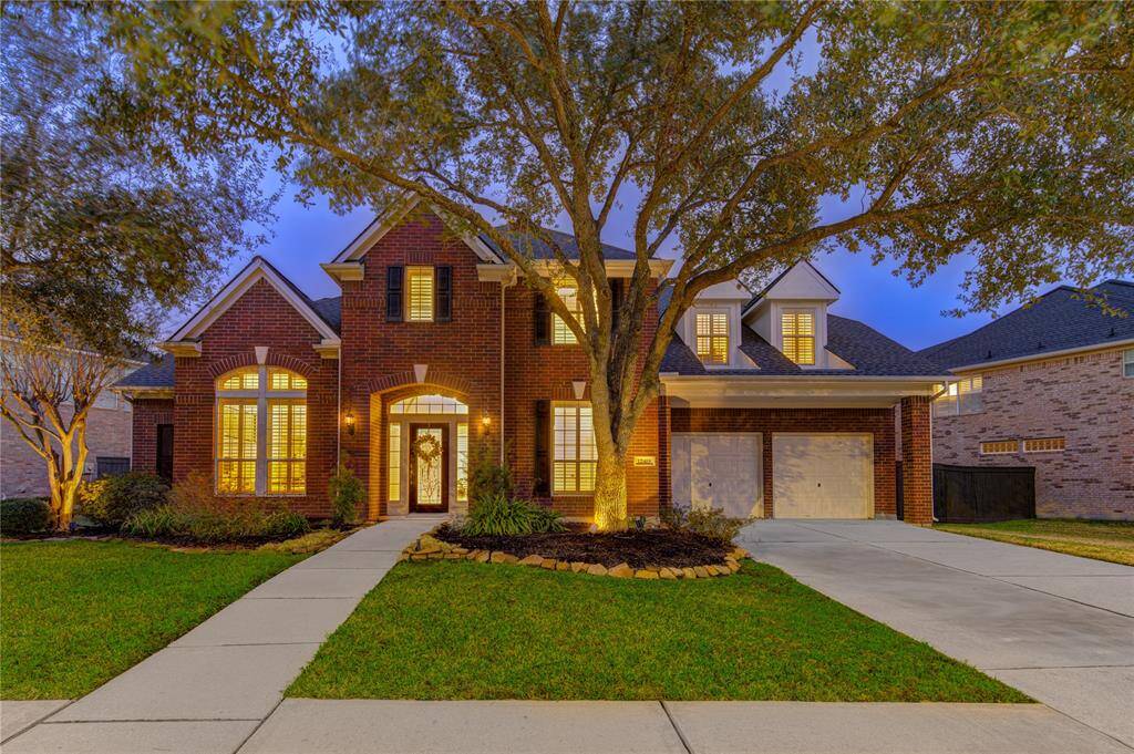Thoughtfully designed, the elevation features symmetrical windows with plantation shutters, adding to the home’s curb appeal. The recently lead glass front door offers a fresh, inviting touch, while the lush greenery frames the home beautifully. A true standout in the desirable Lakes on Eldridge North community!