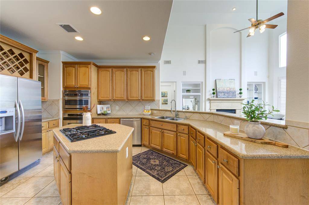 A chef’s delight! This open kitchen features granite countertops, a gas cooktop, a spacious island, and ample cabinetry. The breakfast bar overlooks the living room, making it perfect for entertaining.