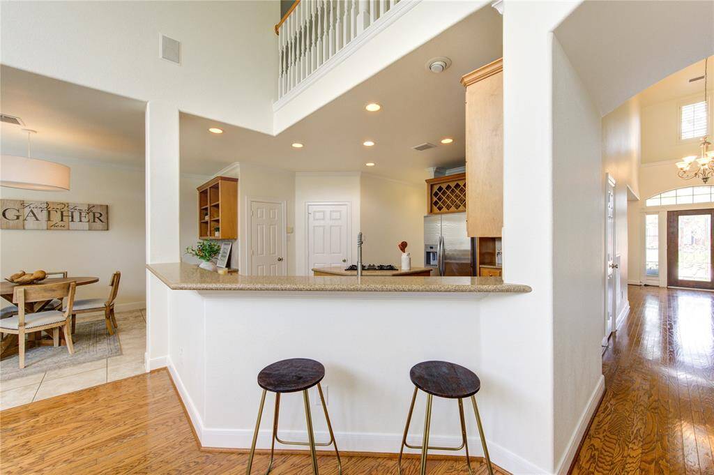 A cozy breakfast bar faces the kitchen, creating the perfect spot for casual dining or morning coffee.