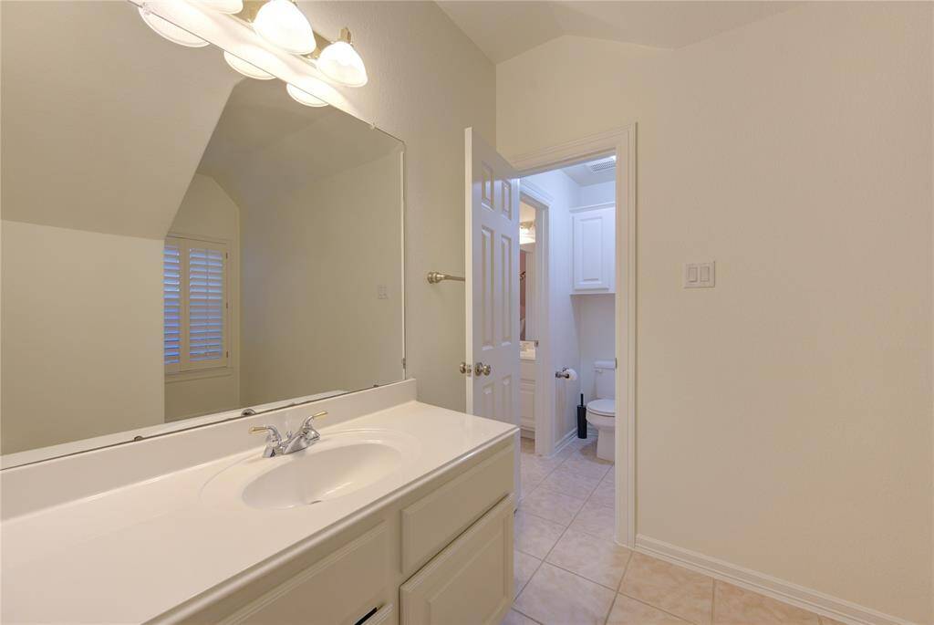 Both secondary bathrooms on the second floor are designed in neutral tones, creating a timeless and elegant look. Each bathroom features pristine countertops, modern faucets, and well-maintained cabinetry, providing a clean and polished feel.