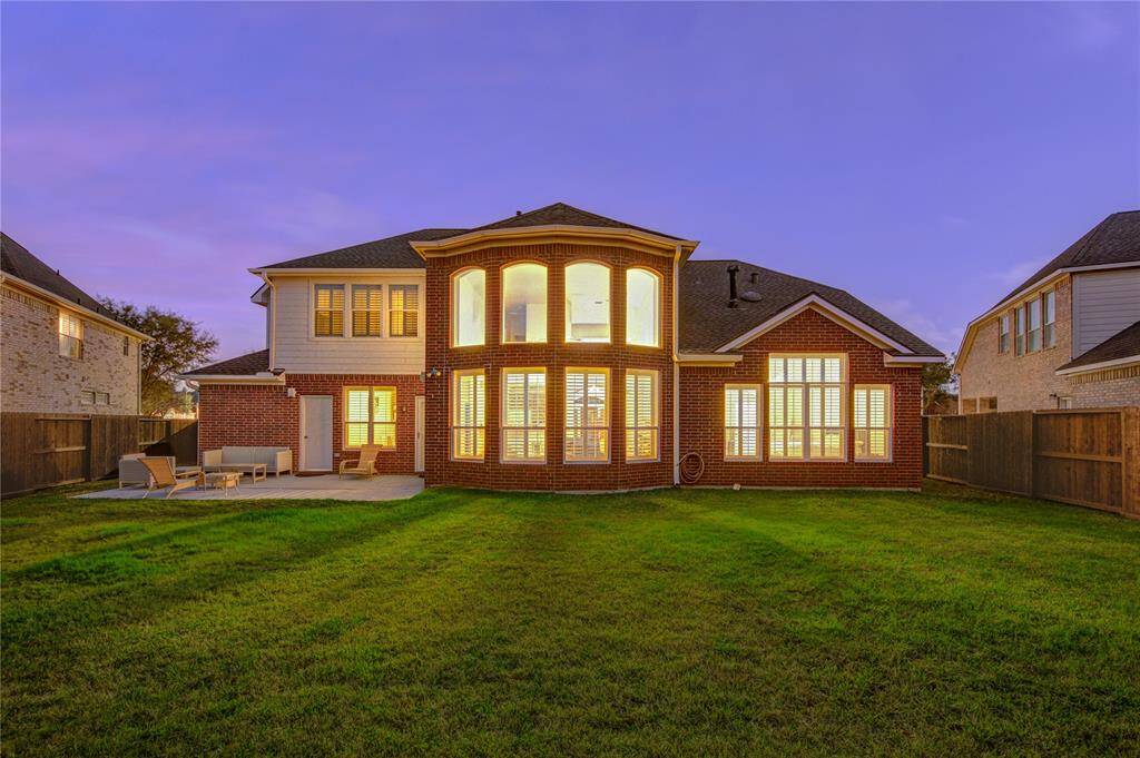 Enjoy privacy in this spacious backyard with a large patio and plenty of green space—perfect for outdoor relaxation and entertaining.