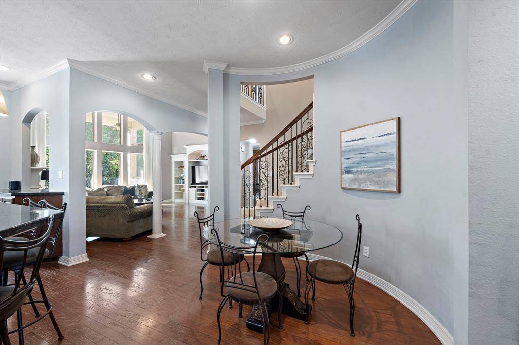 Adjacent to the kitchen, the breakfast nook, with ample seating, offers a cozy spot for casual meals with direct access to the living room.