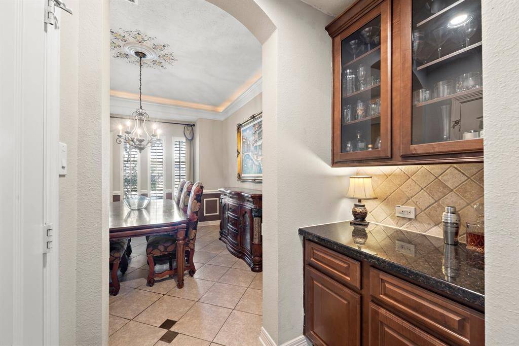 The formal dining room is elevated by a well-appointed dry bar, making it a perfect setting for gatherings and celebrations.