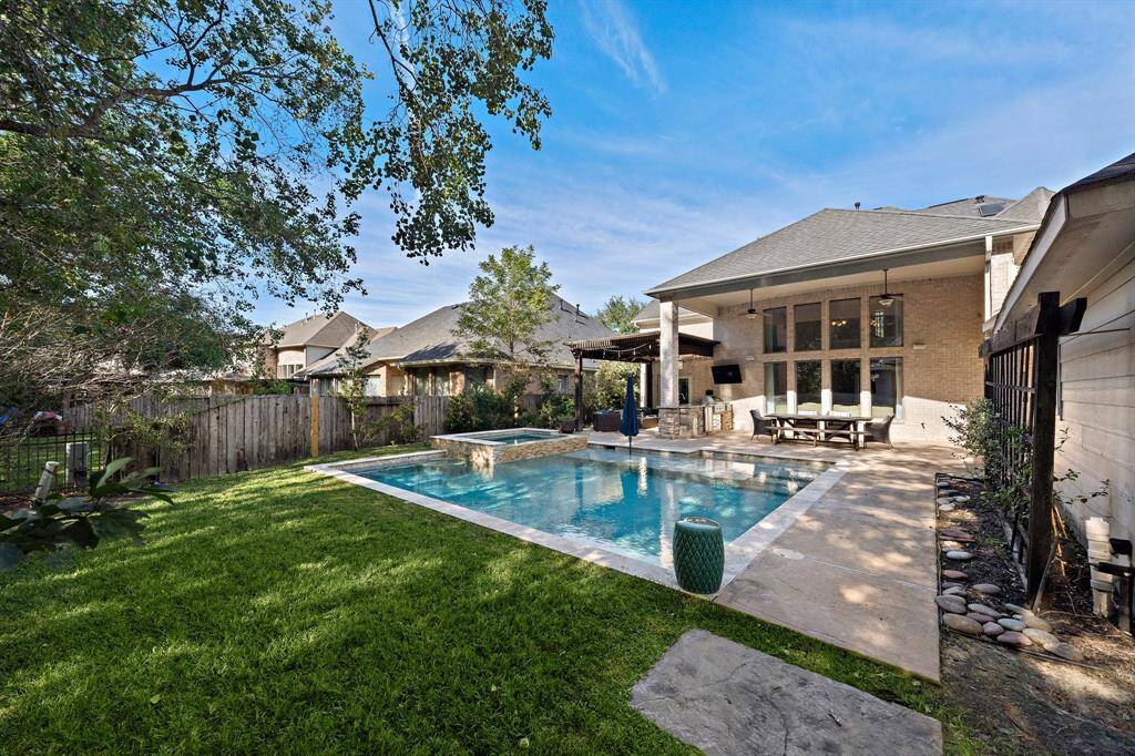 Surrounded by lush greenery, this private retreat offers the perfect setting for entertaining or unwinding in style.