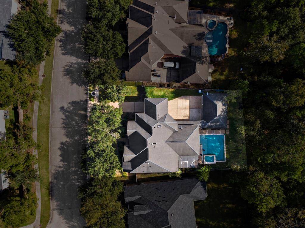 Set on an expansive 11,236 sq ft lot, this property boasts a generous covered patio, a sparkling saltwater pool, a soothing hot tub, and the added privacy of backing onto a peaceful nature reserve.