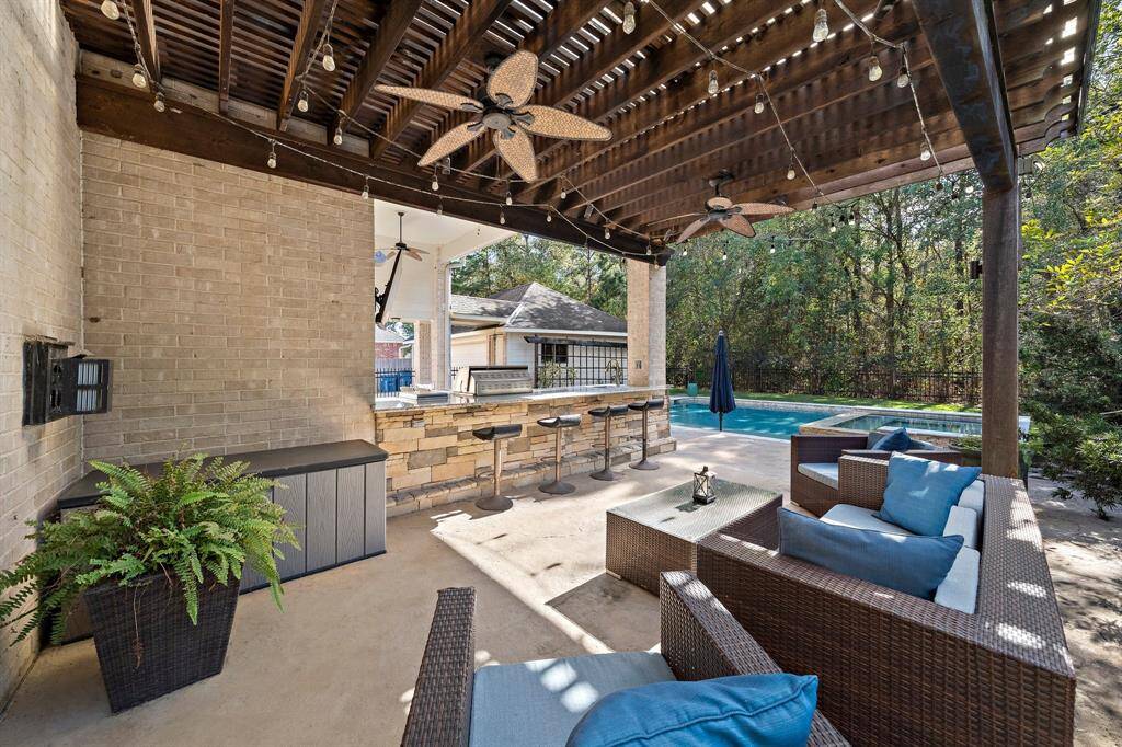 Designed for both entertaining and relaxation, the patio includes a stylish outdoor kitchen and plenty of room for seating. It offers stunning views of the sparkling saltwater pool and the serene nature preserve beyond.