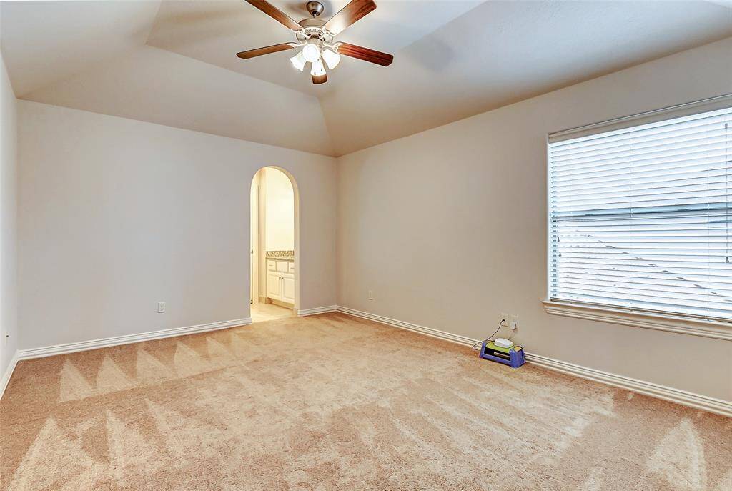 Generously sized secondary bedrooms offer ample space, each featuring a large walk-in closet for excellent storage. Vaulted ceilings and ceiling fans enhance comfort, while large windows bring in abundant natural light.