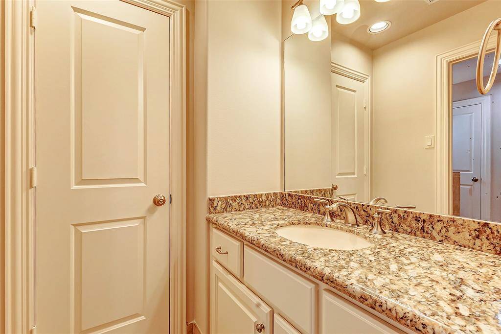 Each bedroom includes a personal vanity area with granite countertops and cabinet storage, seamlessly connecting to a shared Jack-and-Jill bathroom.