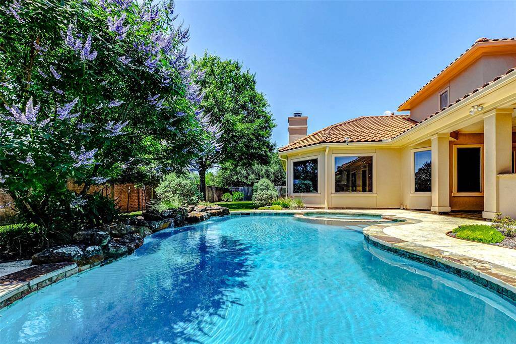 The serene backyard is a nature lover’s retreat, attracting birds and butterflies, and features custom landscaping with drought- and freeze-resistant native perennials. A spacious lawn provides an ideal play area for kids and pets, with extra French drains for improved drainage.