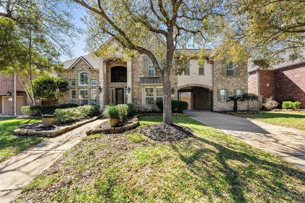 This home boasts 4,668 square feet, with 3 garage spaces with a porte cochere, and a private gated entrance.