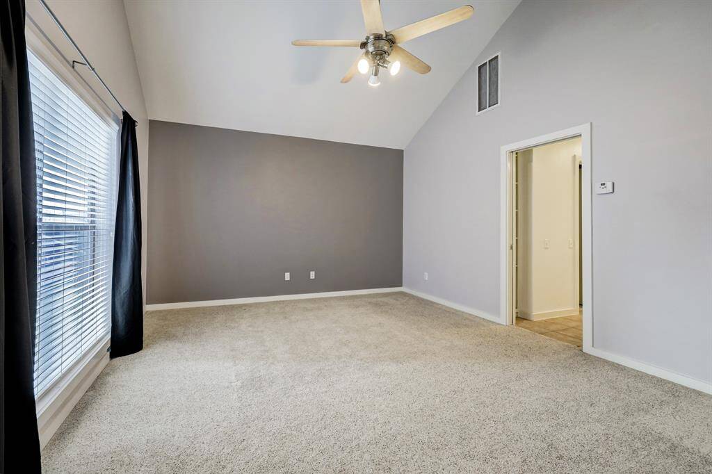 Primary bedroom featured without furnishings.