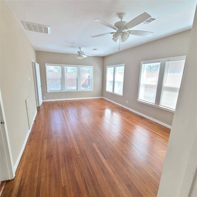 sprawling primary bedroom. Enough space for sitting area. Notice TWO ceiling fans