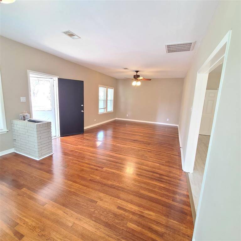 Spacious living room, looking towards front door. Check out the retro brick indoor planter