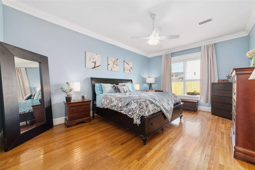 A spacious, light-filled primary suite with views of both the back deck and the front porch.
