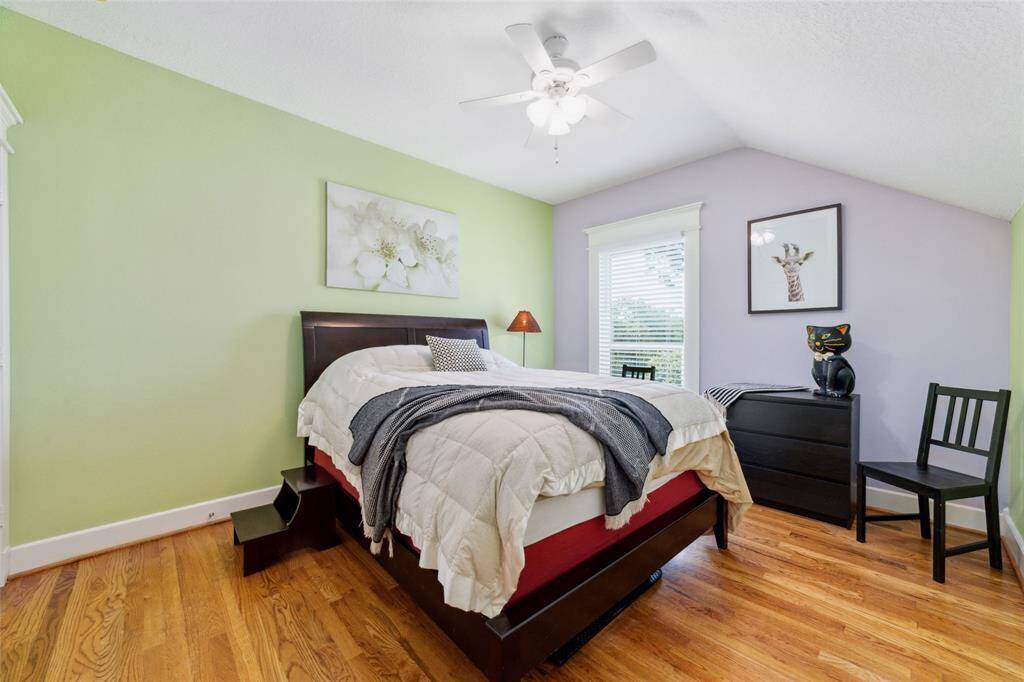 Bedroom Three features a spacious walk-in closet and two of three walk-in attic storage spaces.