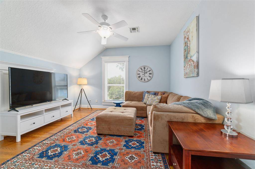 A flexible Family/Game/Media Room featuring a hideaway TV nook and French doors for privacy.