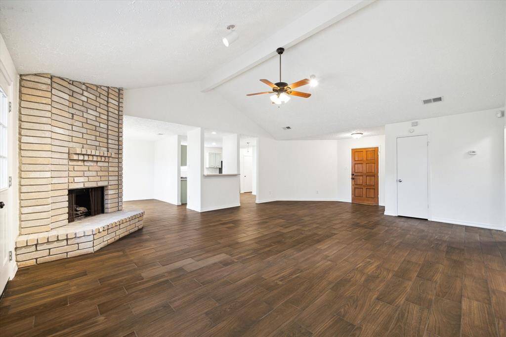 This open floor plan features a spacious family room with a fireplace. The vaulted ceiling adds character to the home. You'll find fresh neutral finishes throughout the home.
