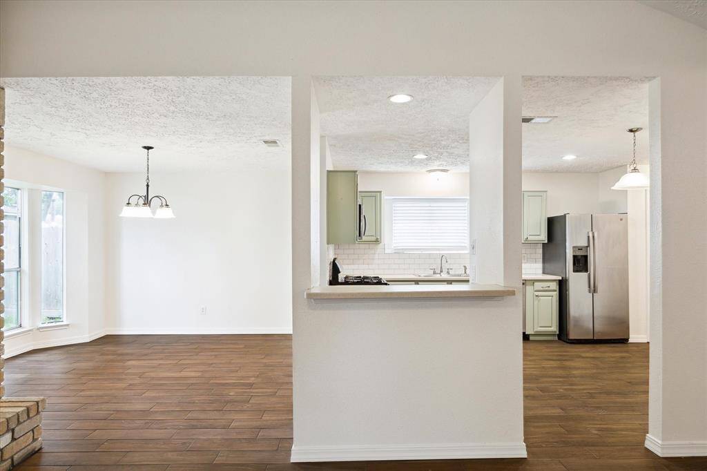 The kitchen is separated from the family room by this pass-through opening with a breakfast bar. This is a handy feature for serving drinks and snacks to guests or add bar stools to create additional seating.