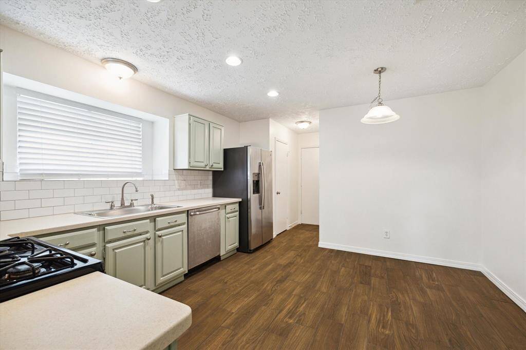Ditch the takeout and cook from home more often. This well-equipped updated kitchen boasts plenty of counter space, making meal prep and cleanup a breeze. With abundant cabinetry and a spacious pantry, you'll have ample storage for all your favorite kitchen gadgets here.
