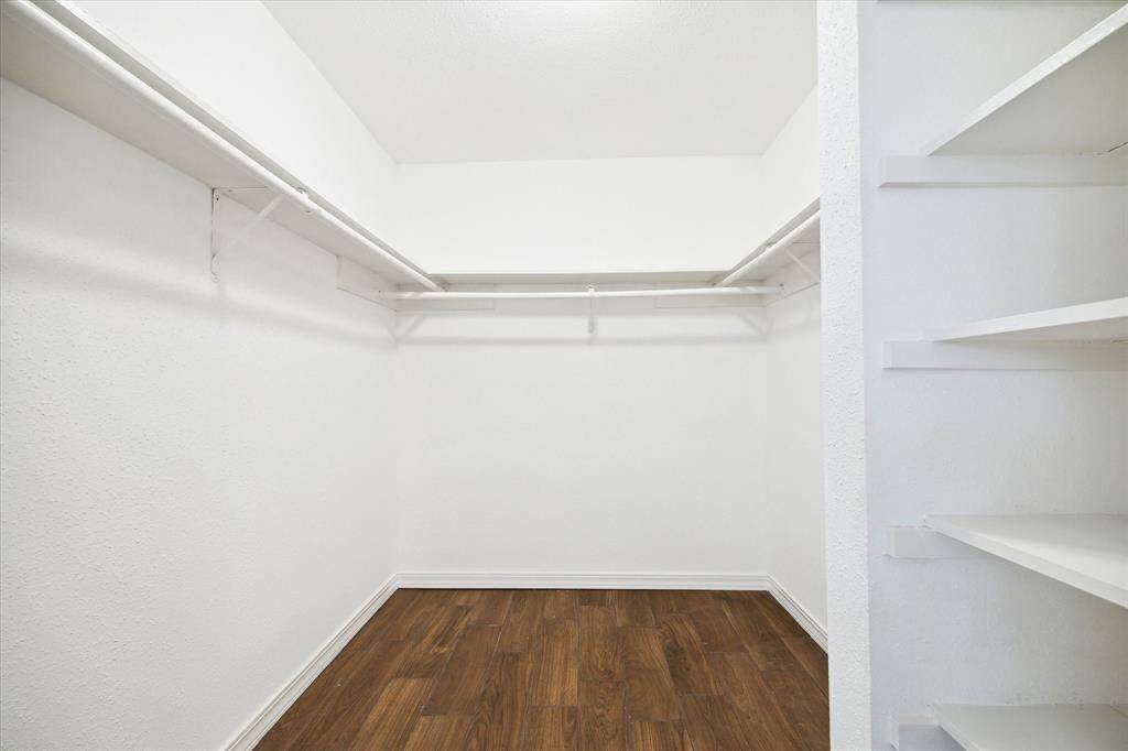 The primary bedroom's walk-in closet has ample space for hanging clothes, shoes, bags and more. So, shop until you drop, this closet can take it!