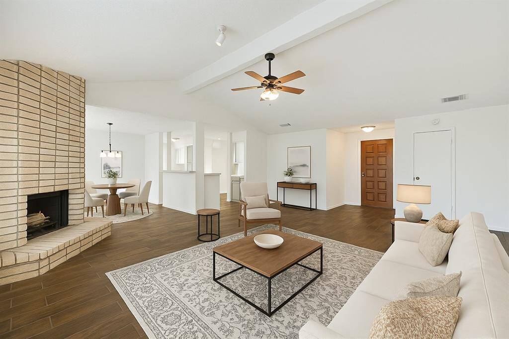 Virtually staged - This open floor plan features a spacious family room with a fireplace. The vaulted ceiling adds character to the home. You'll find fresh neutral finishes throughout the home.