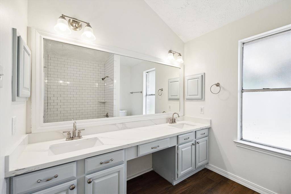 The primary bedroom features a beautifully updated ensuite with quartz countertops, new fixtures and lighting. You'll also find a tub/shower enclosure with beautiful tile work.