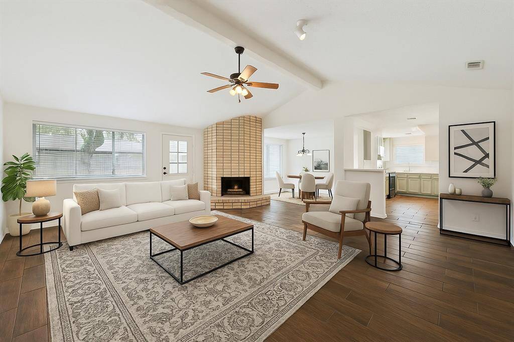 Virtually staged - This home has been beautifully updated from top to bottom with wood-look tile flooring. The Main living area is open to both the Kitchen and dining areas.
